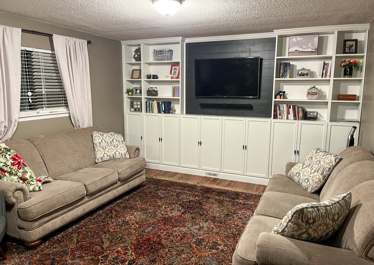 The finished living room with the ikea billy bookcase hack built-ins and a TV mounted on the wall