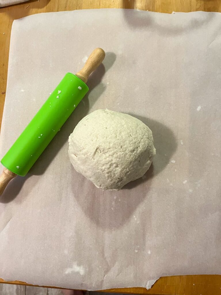 salt dough ball with a rolling pin next to it