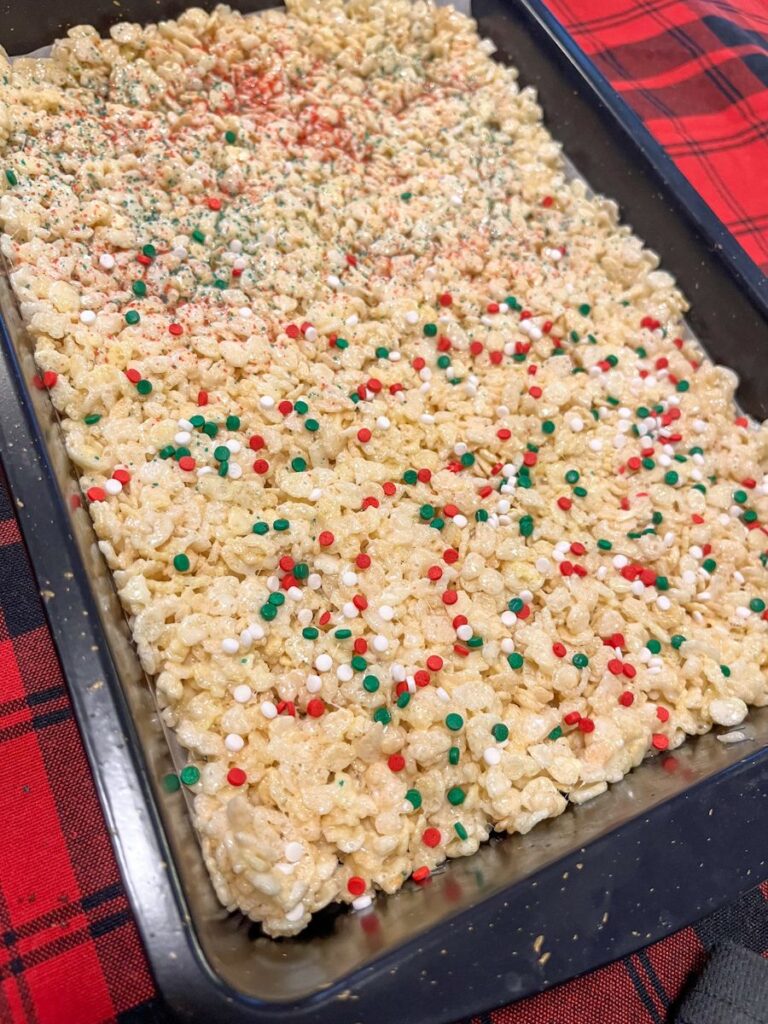 rice krispie treats in a 9 x 13 baking pan with 2 different types of sprinkles
