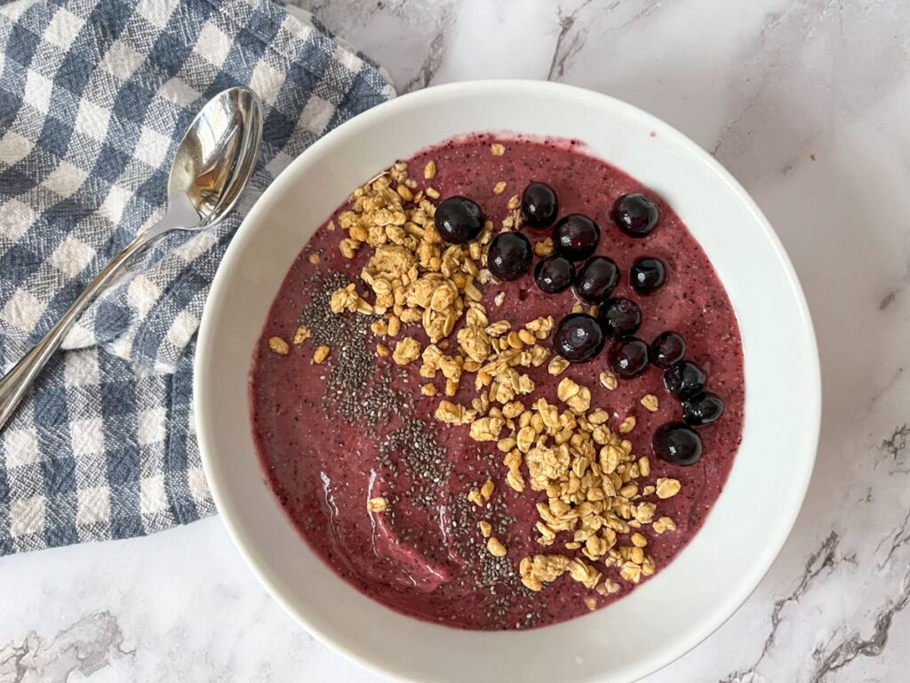 Blueberry and pineapple smoothie bowl served in a bowl with toppings