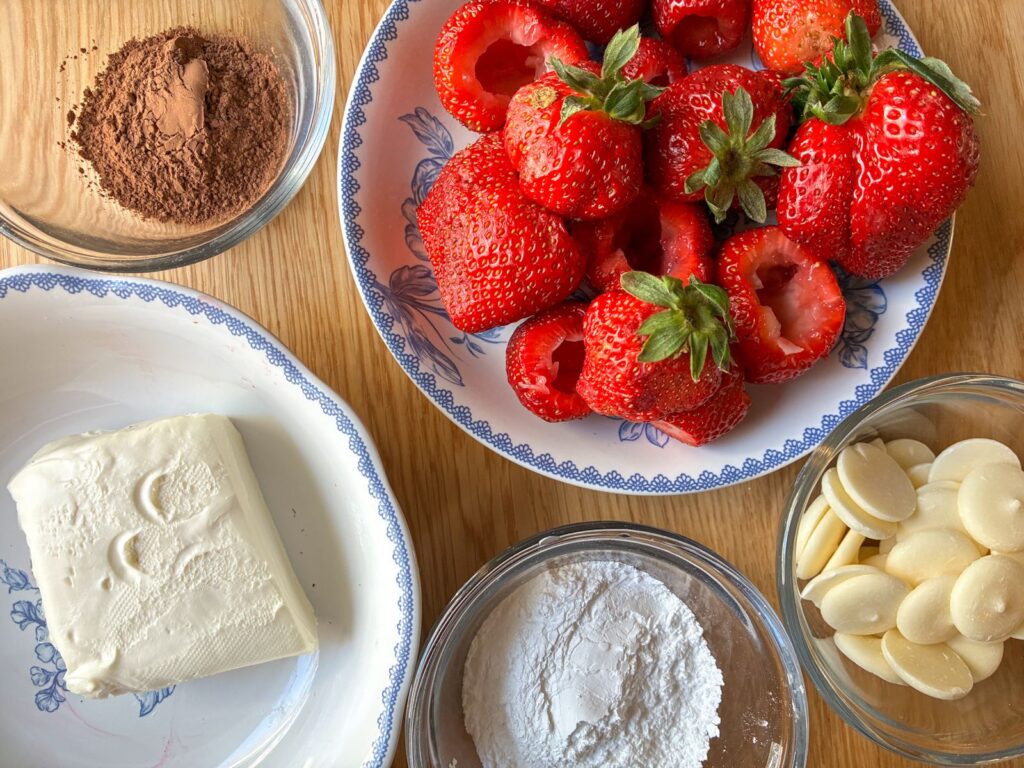 ingredients for chocolate filled strawberries out on a table