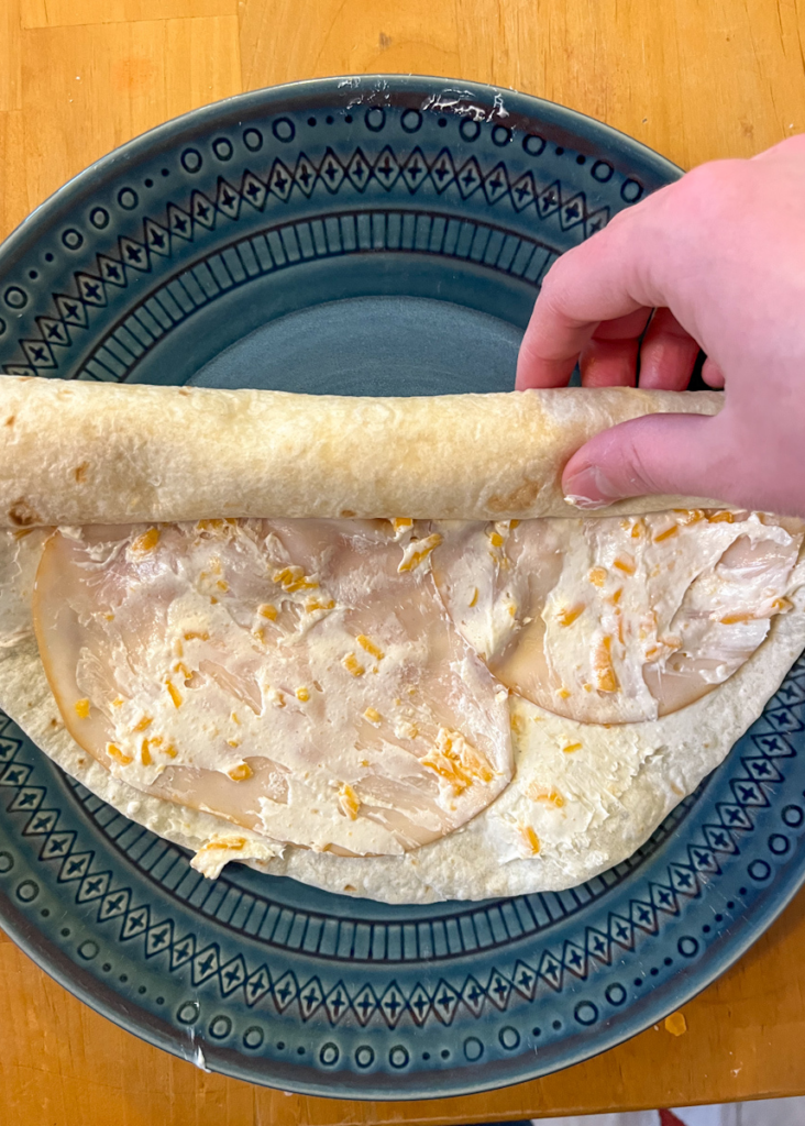 Tortilla halfway through being rolled up