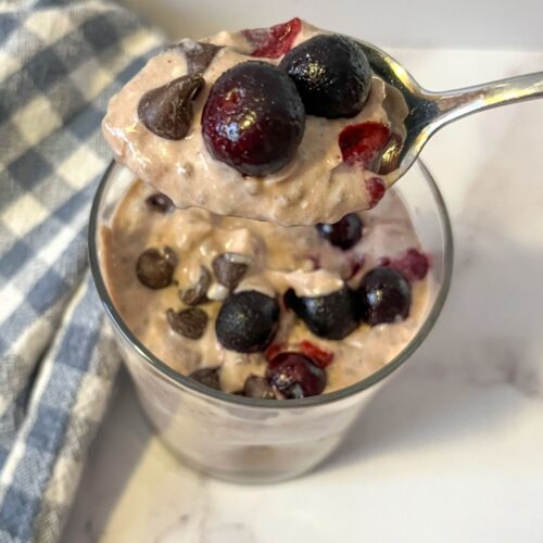 chia seed pudding served in a glass and topped with blueberries and chocolate chips.