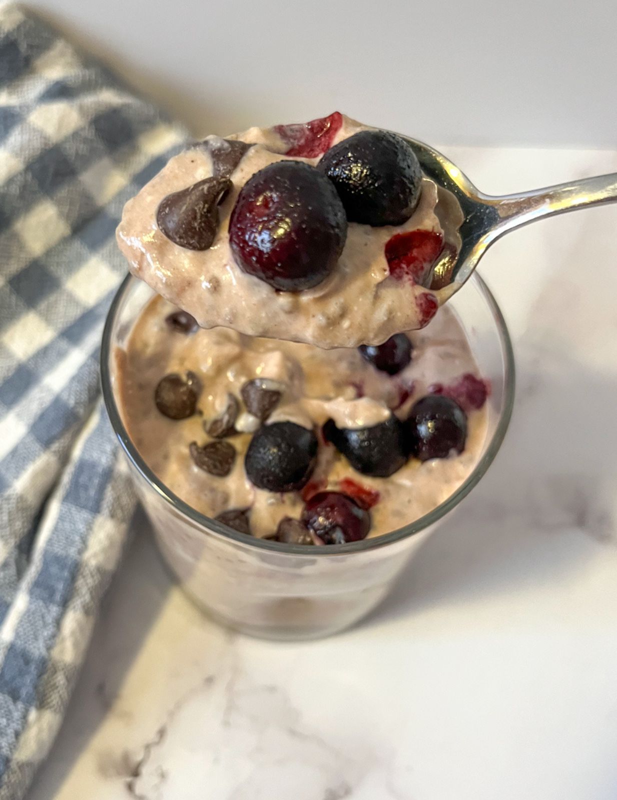 chia seed pudding served in a glass and topped with blueberries and chocolate chips.