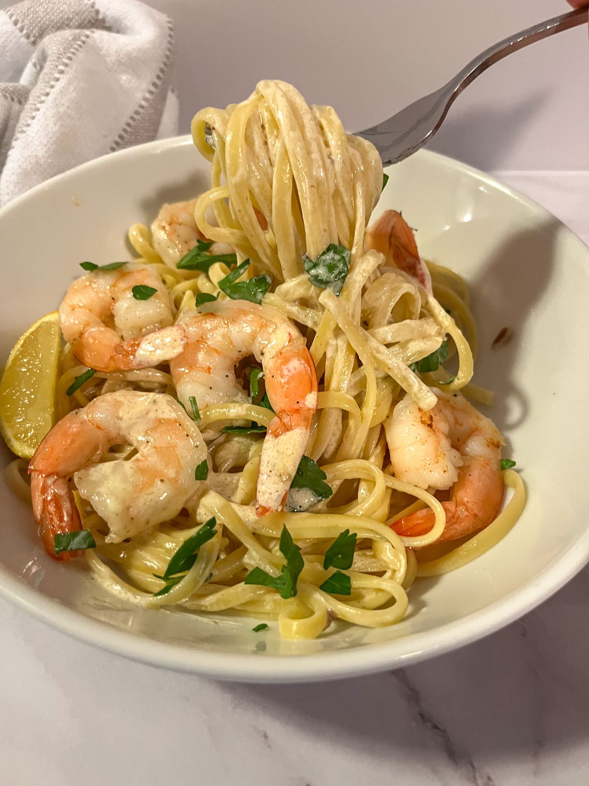 creamy lemon shrimp pasta with a fork twirling the pasta