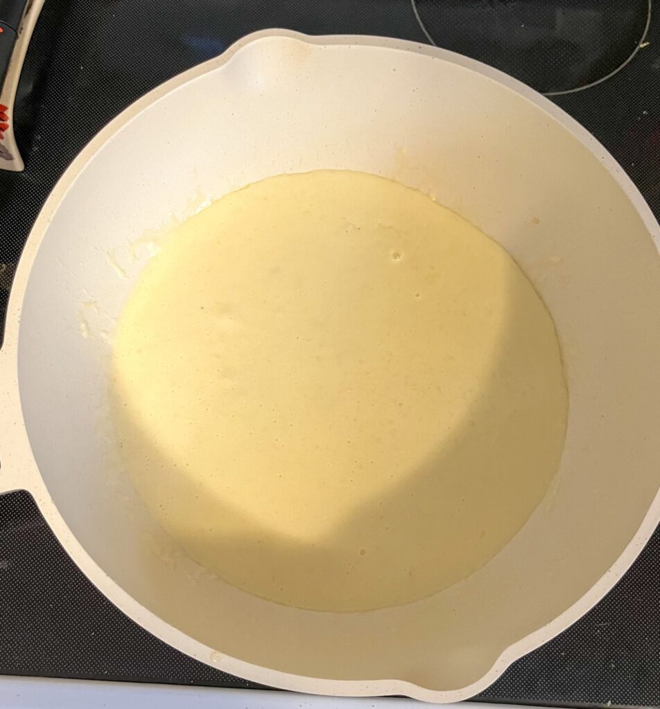 Finished lemon cream sauce in a saucepan