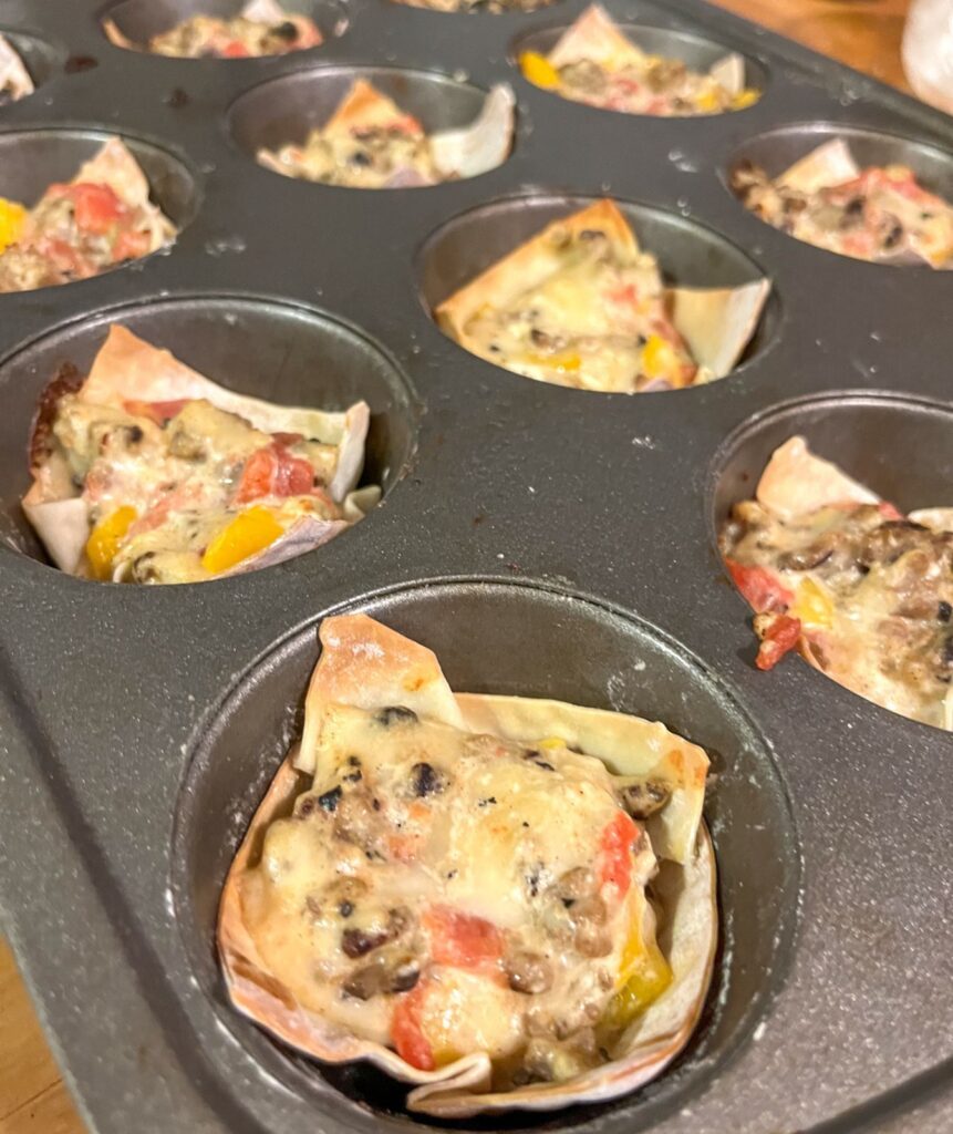 sausage cups in a muffin tin after they have been baked.