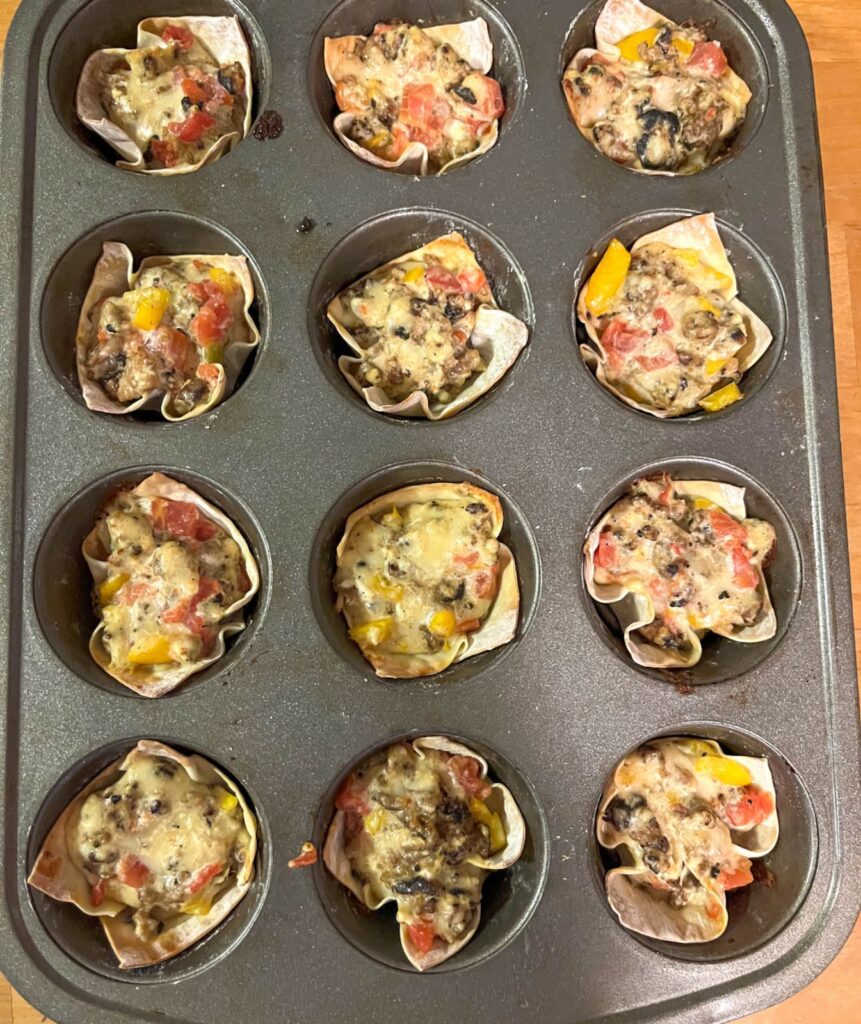 wonton wraps filled with the mixture after it has been baked in the oven. Still in the muffin tin.