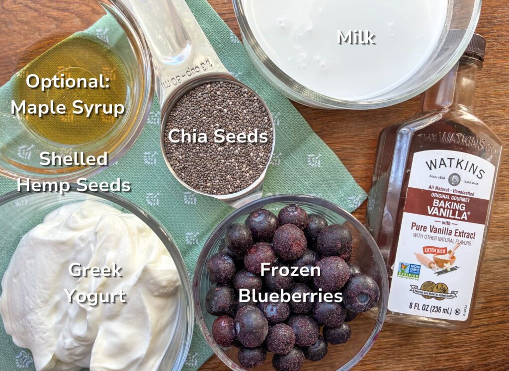 Ingredients of berry chia seed pudding laid out on a table