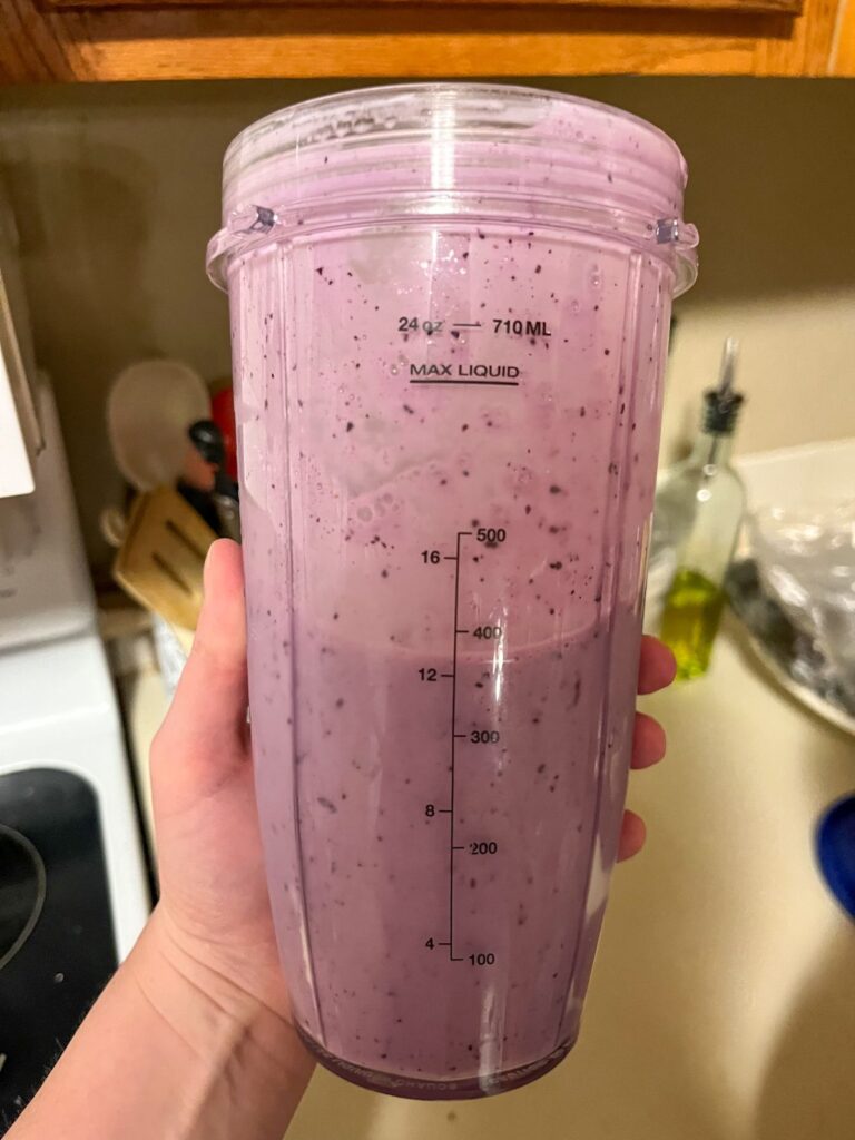 In a blender container the yogurt, milk, and berries after they have been blended