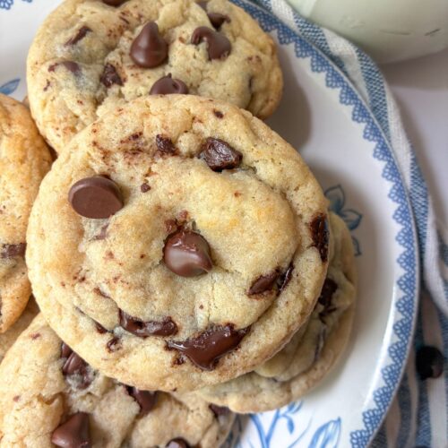 Four eggless chocolate chip cookies on a plate