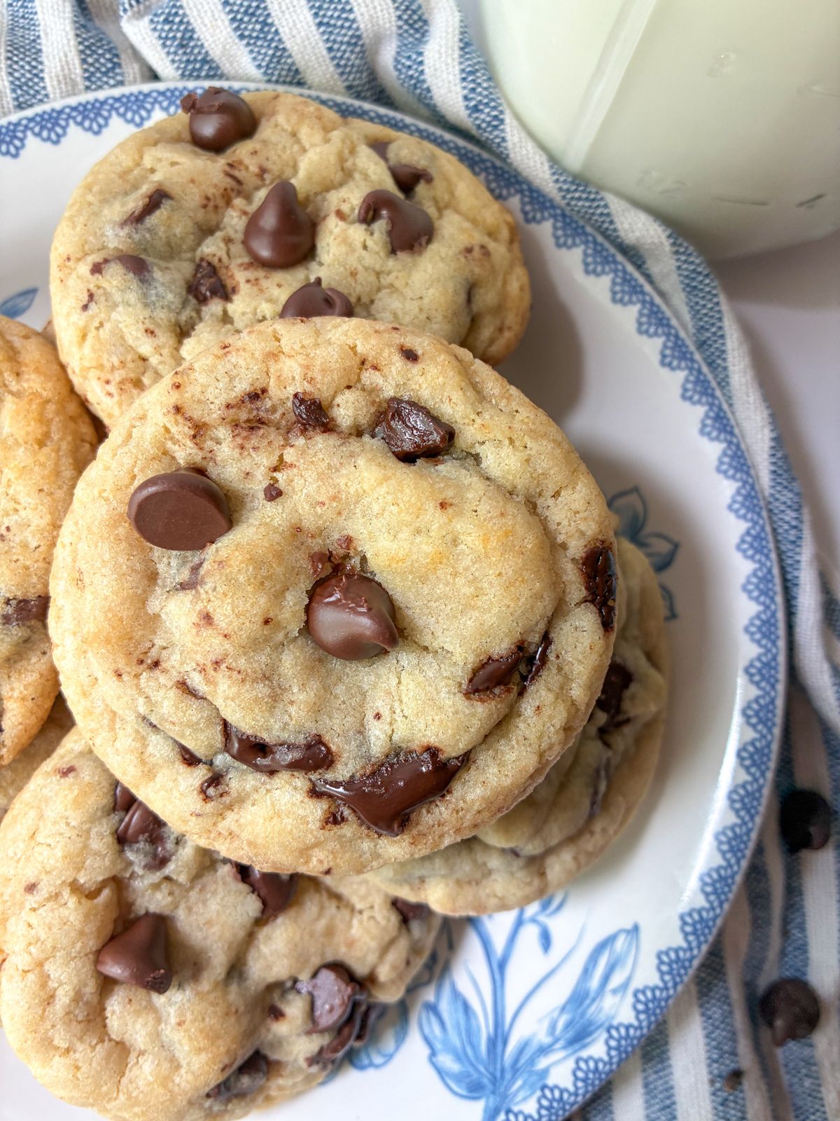 Four eggless chocolate chip cookies on a plate