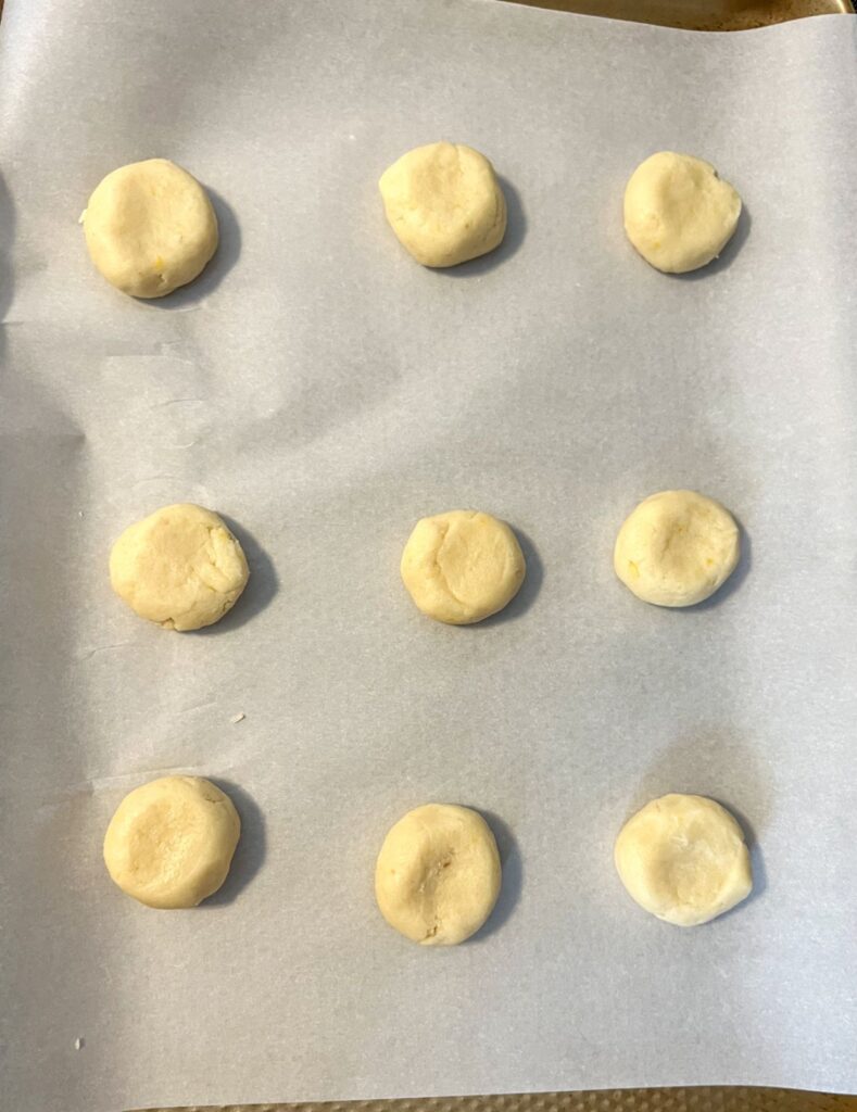 9 dough balls on a baking sheet prior to being baked