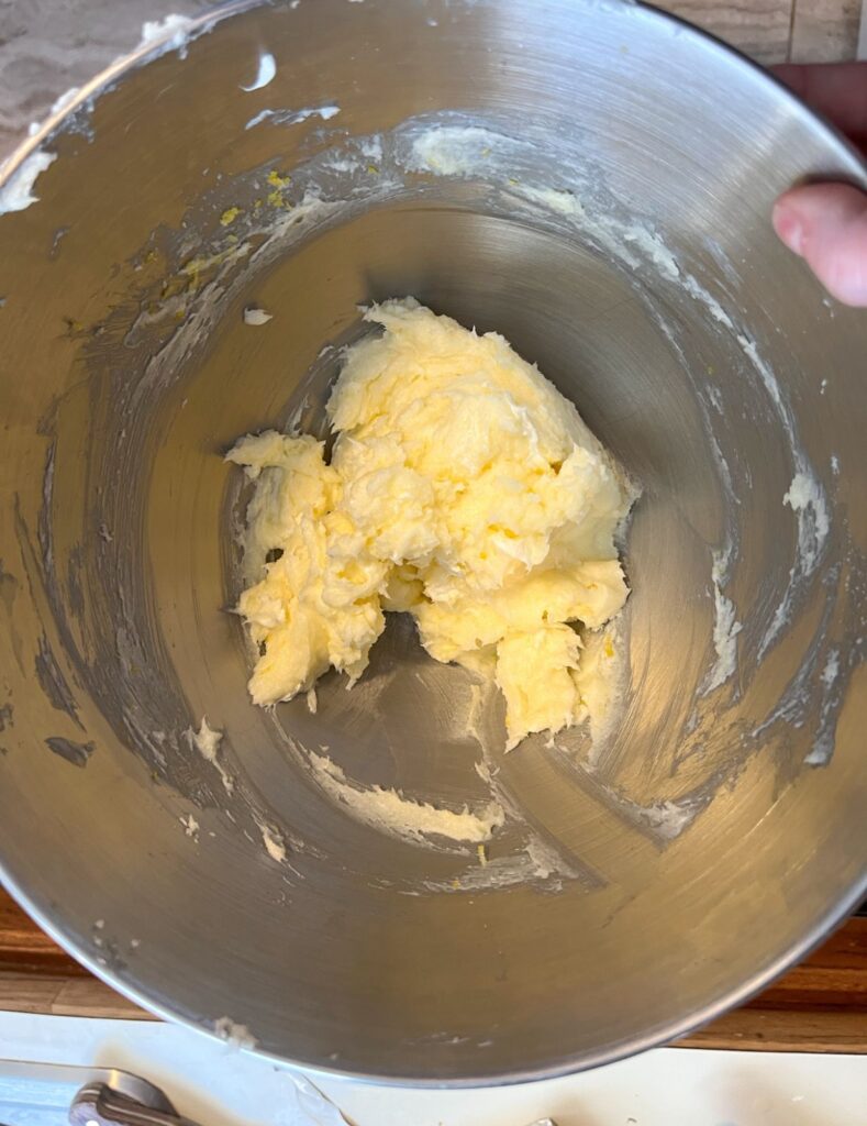sugar, butter, lemon juice, and lemon zest creamed together in a mixing bowl
