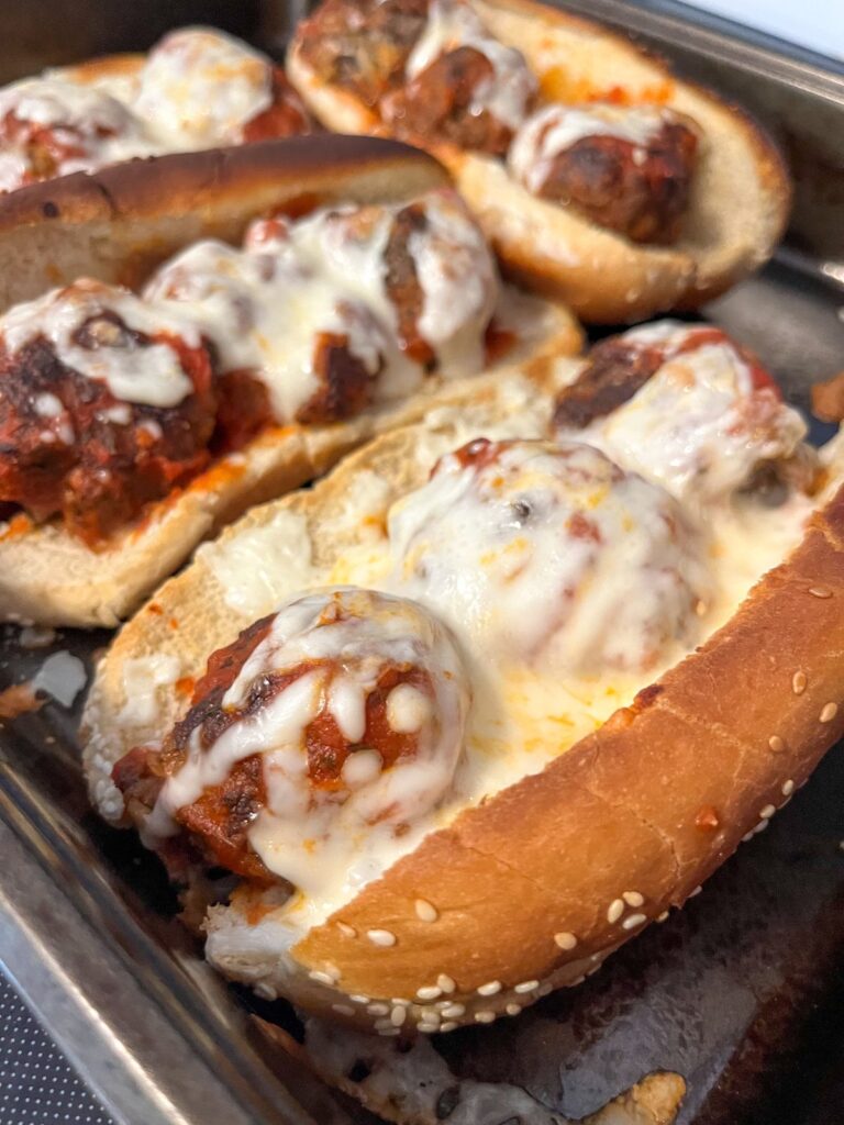 4 meatball subs in a baking sheet