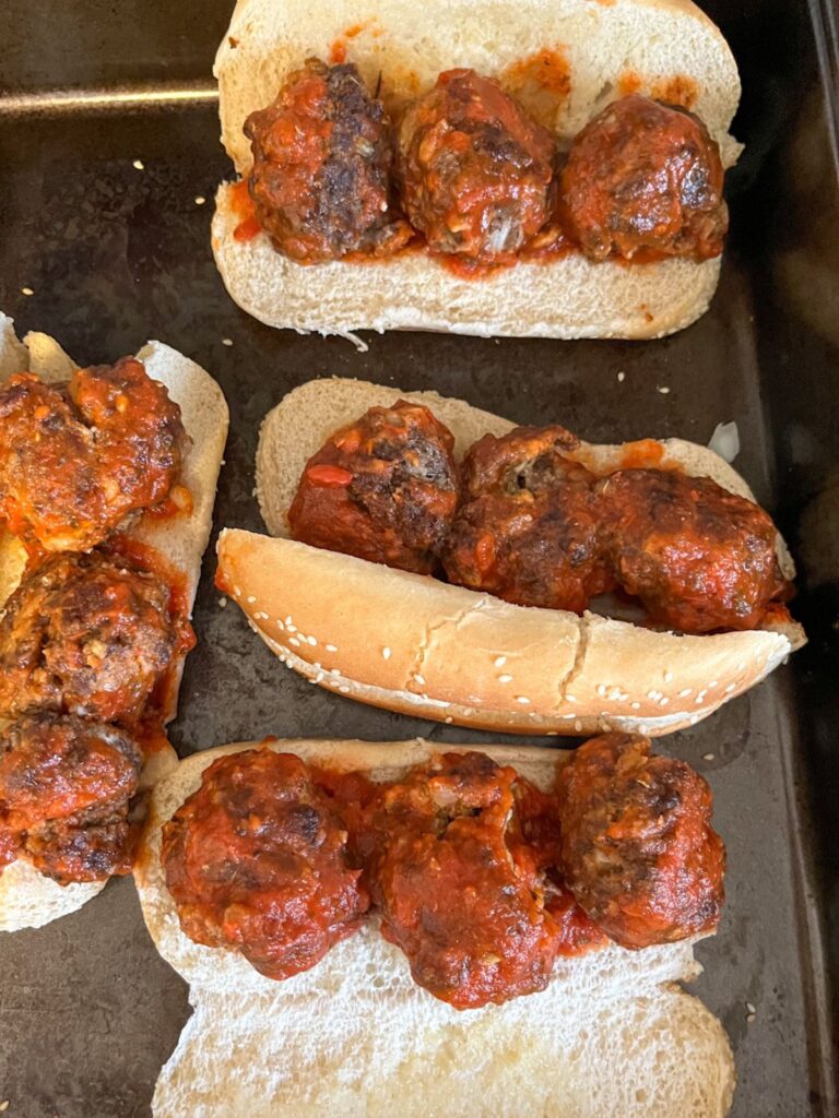 Toasted hoagie rolls with meatballs inside