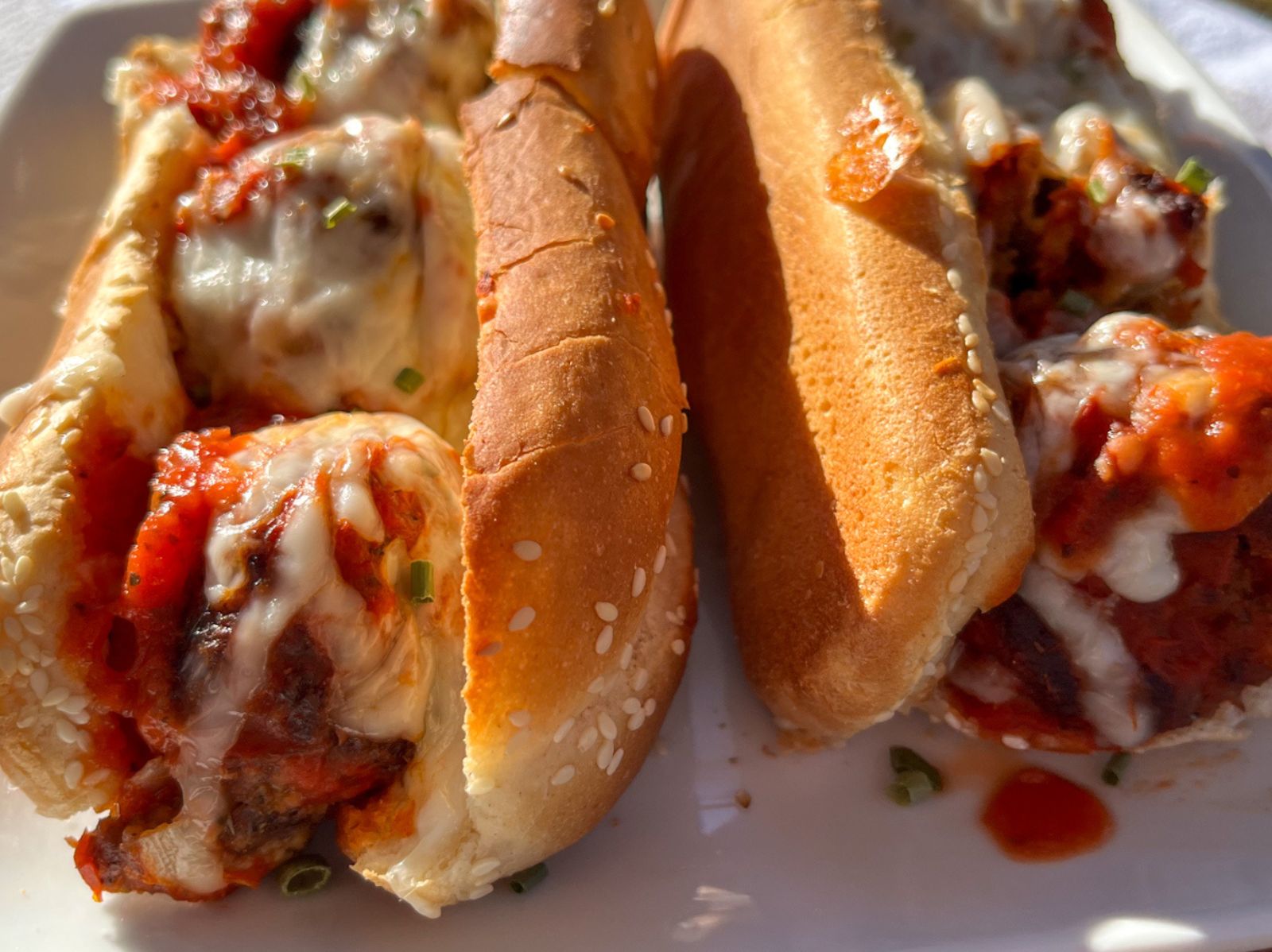 Two eggless meatball subs on a plate