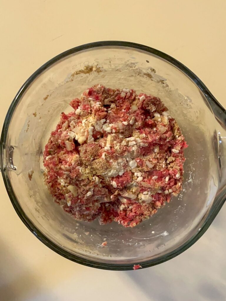 Meatball ingredients mixed together in a bowl