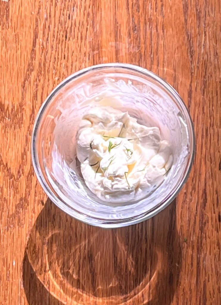 Cream cheese mixture in a bowl for smoked salmon bagel