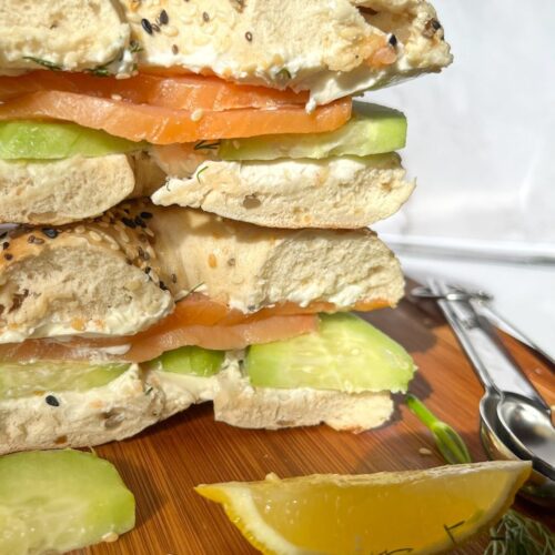 Smoked salmon bagel with ingredients around it