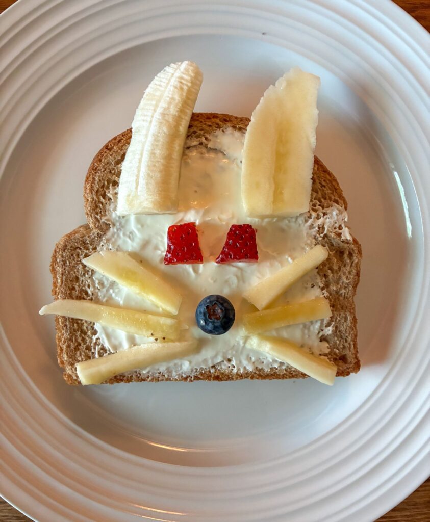 Toast with a bunny face made out of fruit
