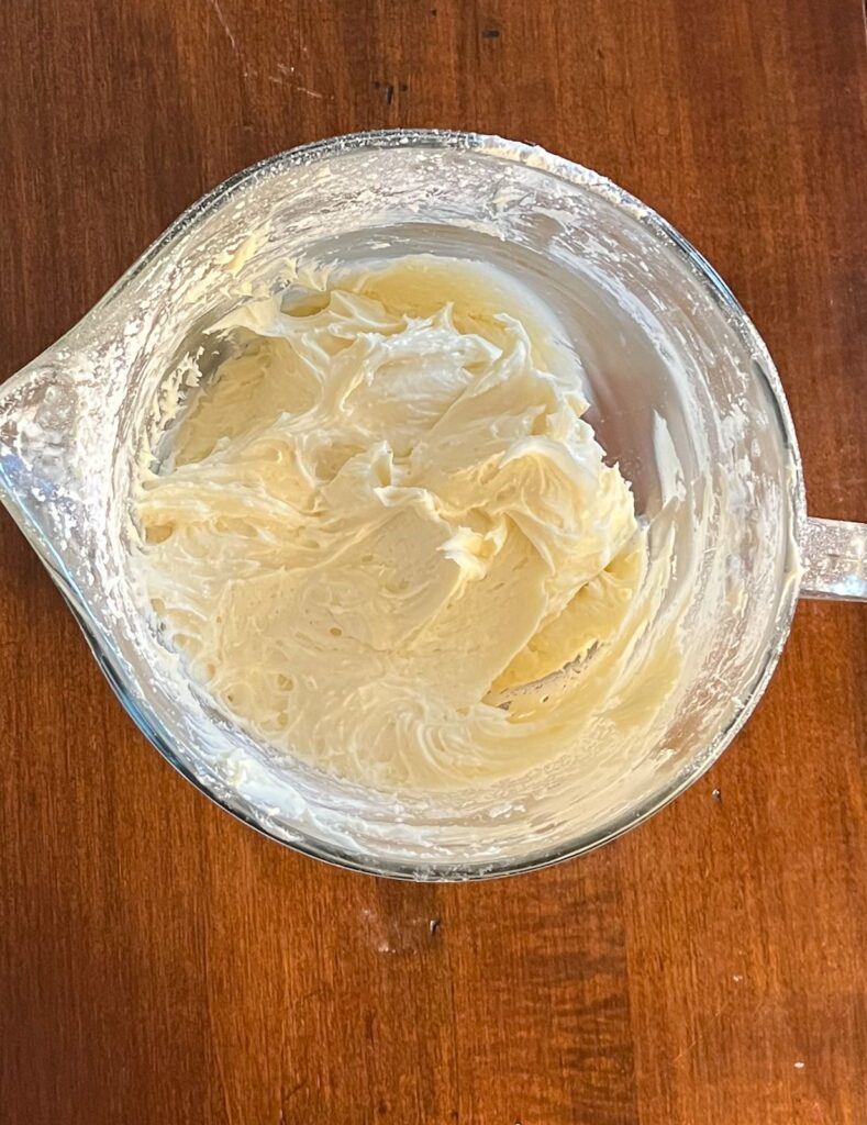 Cream cheese frosting in a large bowl