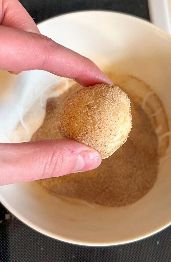 snickerdoodle dough balls rolled in cinnamon sugar