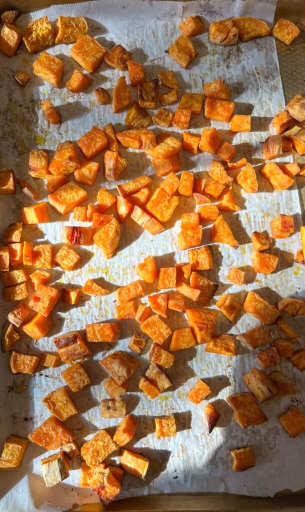 Sweet potatoes on a roasting pan fresh out of the oven.