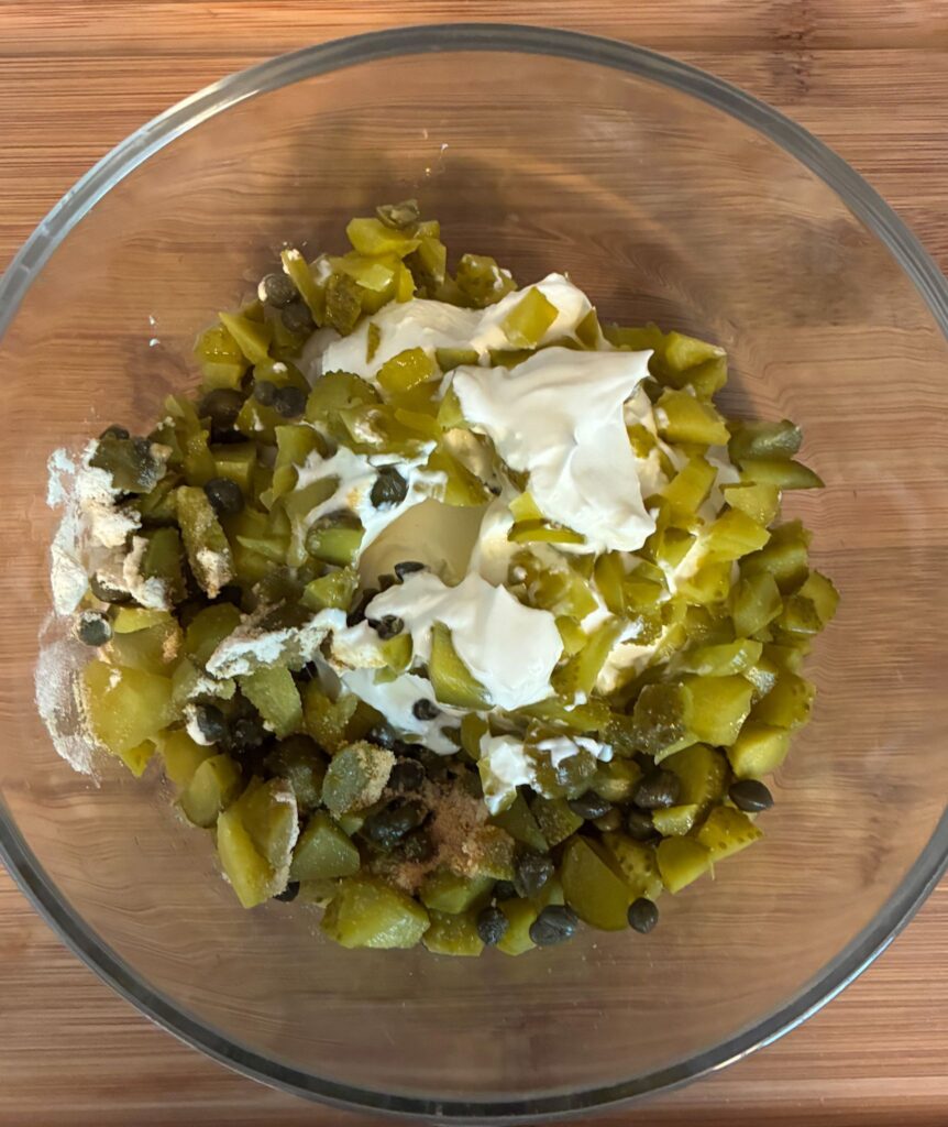Ingredients combined in a bowl For TarTar Sauce Without Mayonnaise