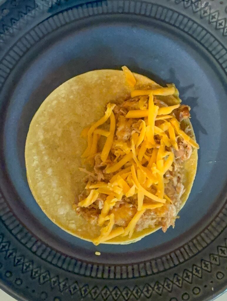 Corn tortilla with filling before its been folded in half
