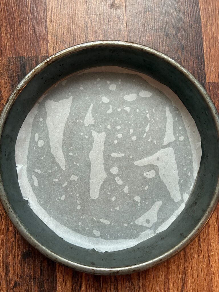Oiled cake pan with parchment paper on the bottom