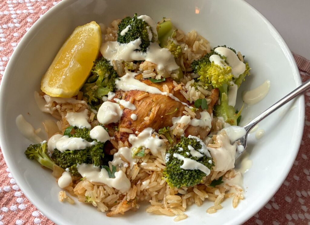 dinner served in a bowl with cream sauce drizzled on top.