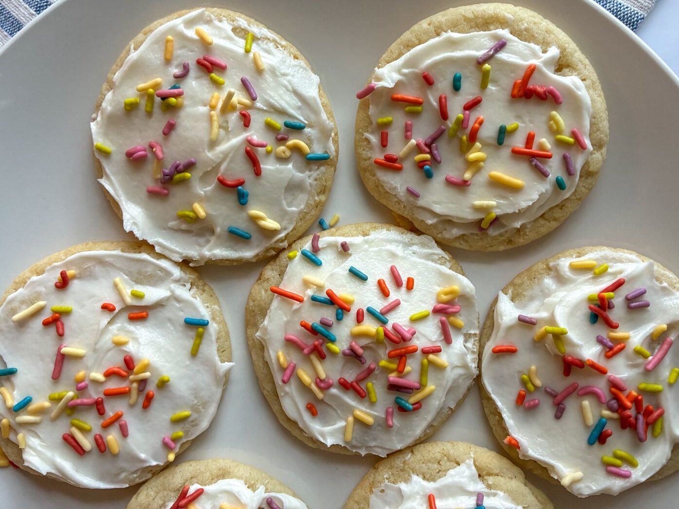 Six eggless sugar cookies on a plate.