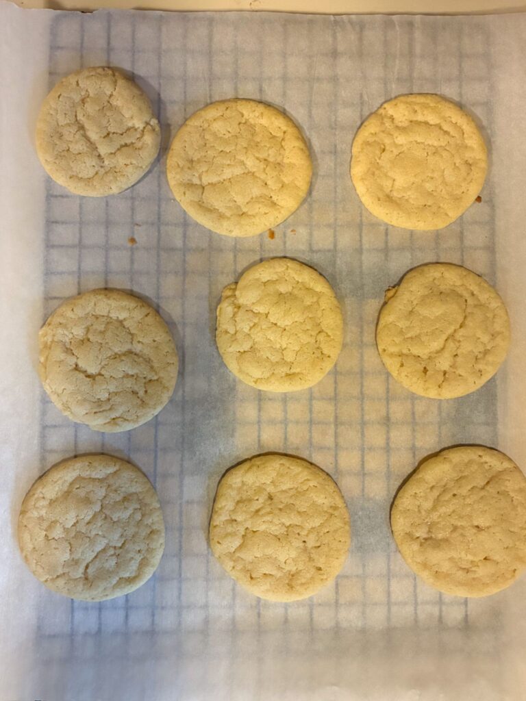 Fresh baked eggless sugar cookies fresh out of the oven and on a cooling rack.