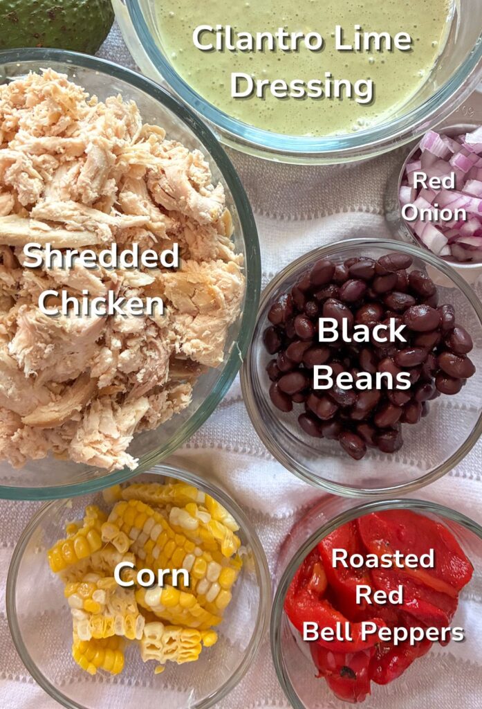 Ingredients in a southwest chicken salad in individual bowls with labels