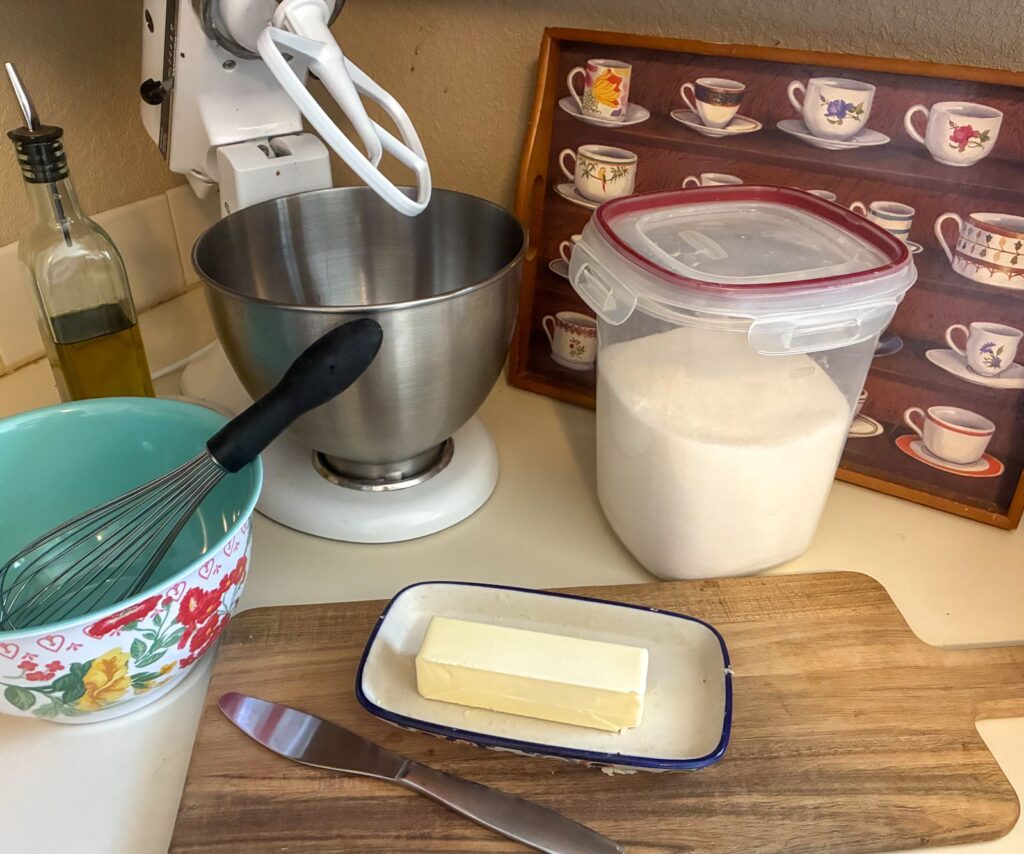 A photo from the authors kitchen with mixing bowl, butter, and sugar