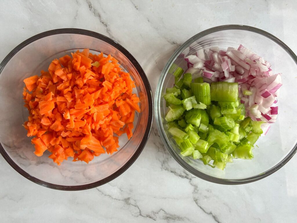 two bowls full of chopped vegetables 