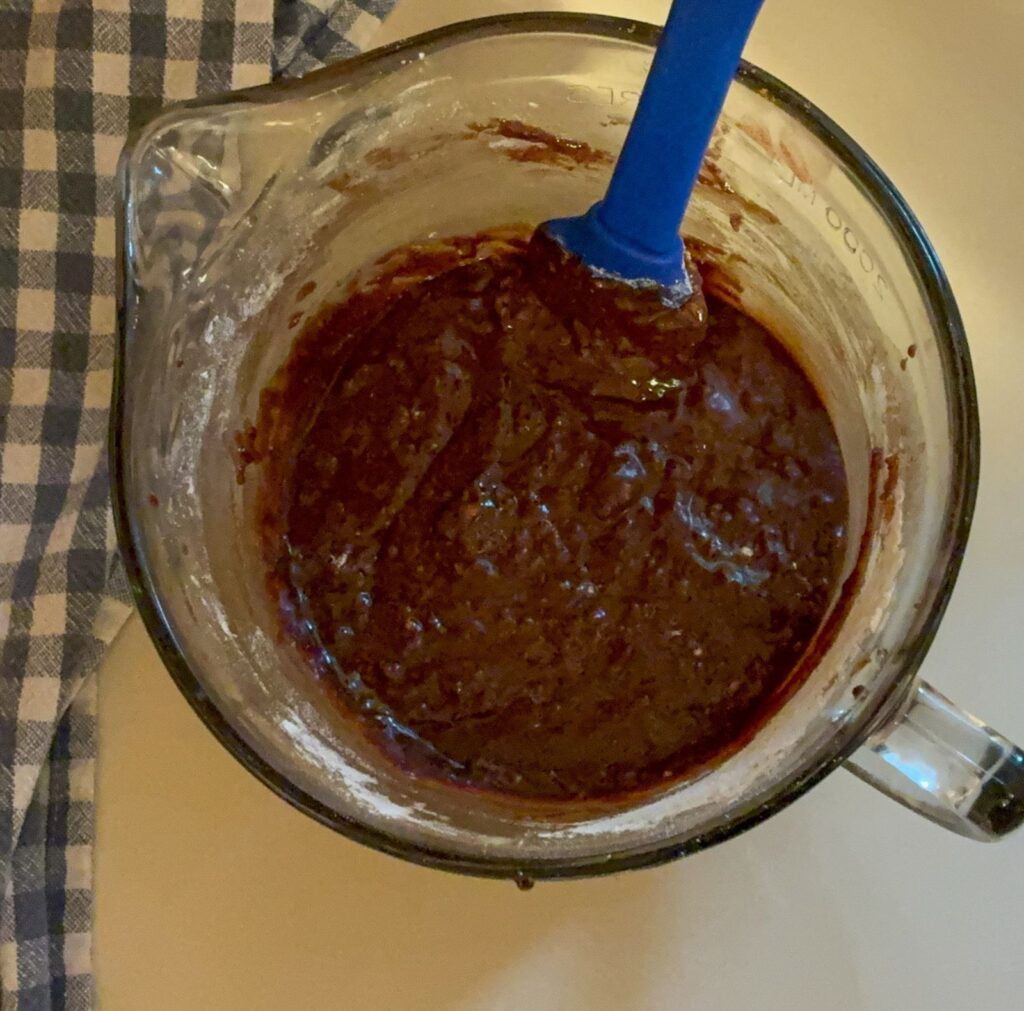 Large mixing bowl with brownie batter in it
