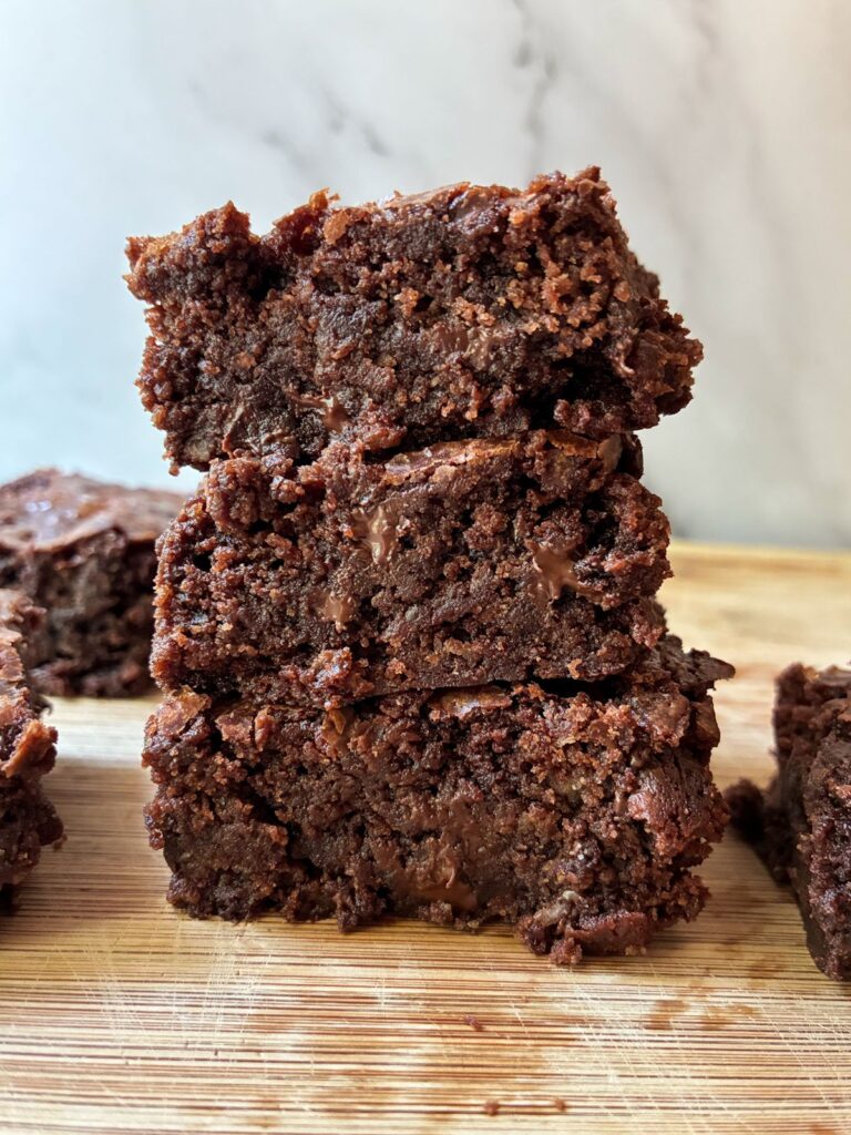 Three eggless fudgy brownies stacked on top of each other