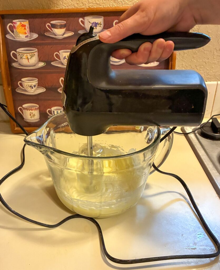 Hand mixer mixing butter