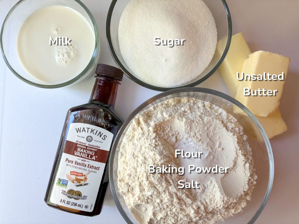ingredients for cut out sugar cookies in bowls laid out on a table