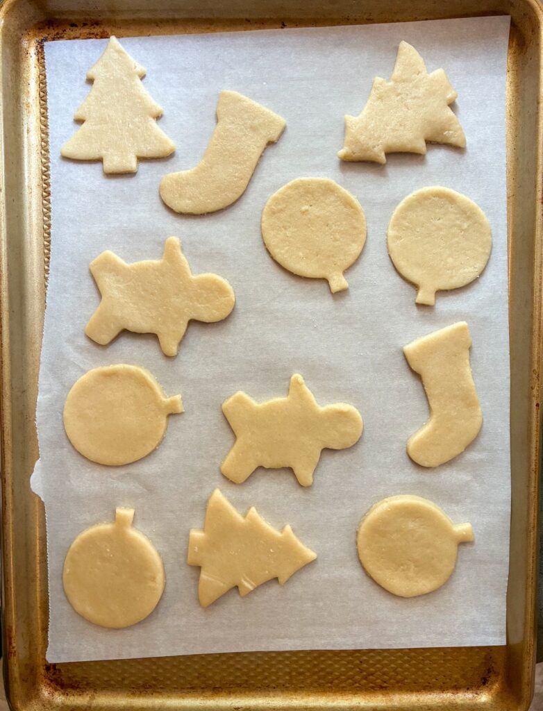 Cut out sugar cookies (eggless) on a baking sheet prior to baking