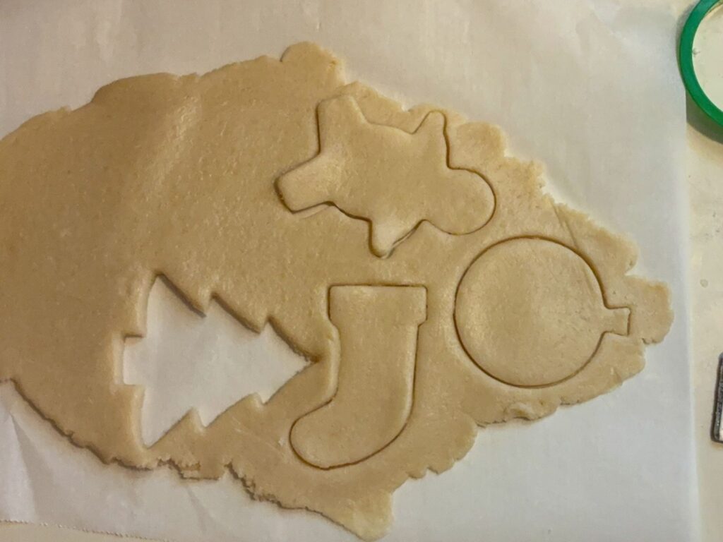 Eggless cut out cookie dough rolled out with cookie cutter shapes cut out