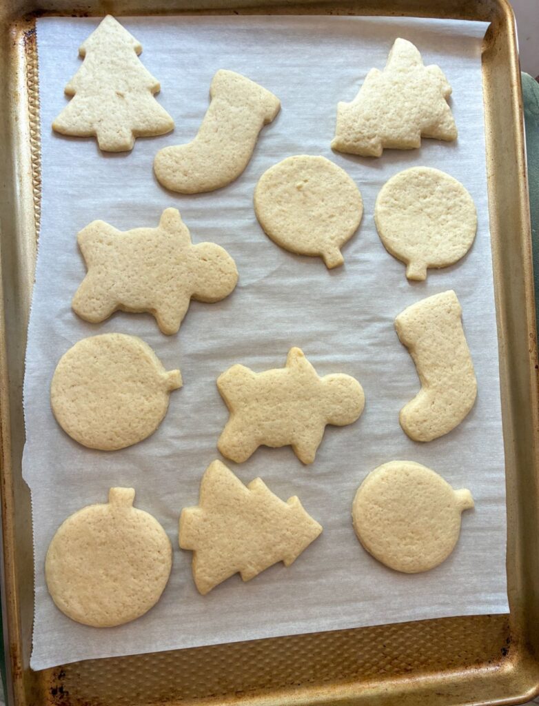 cut out sugar cookies (eggless) fresh out of the oven on a baking sheet