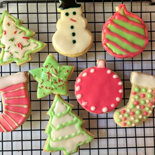 cut out sugar cookies (eggless) decorated and on a drying rack