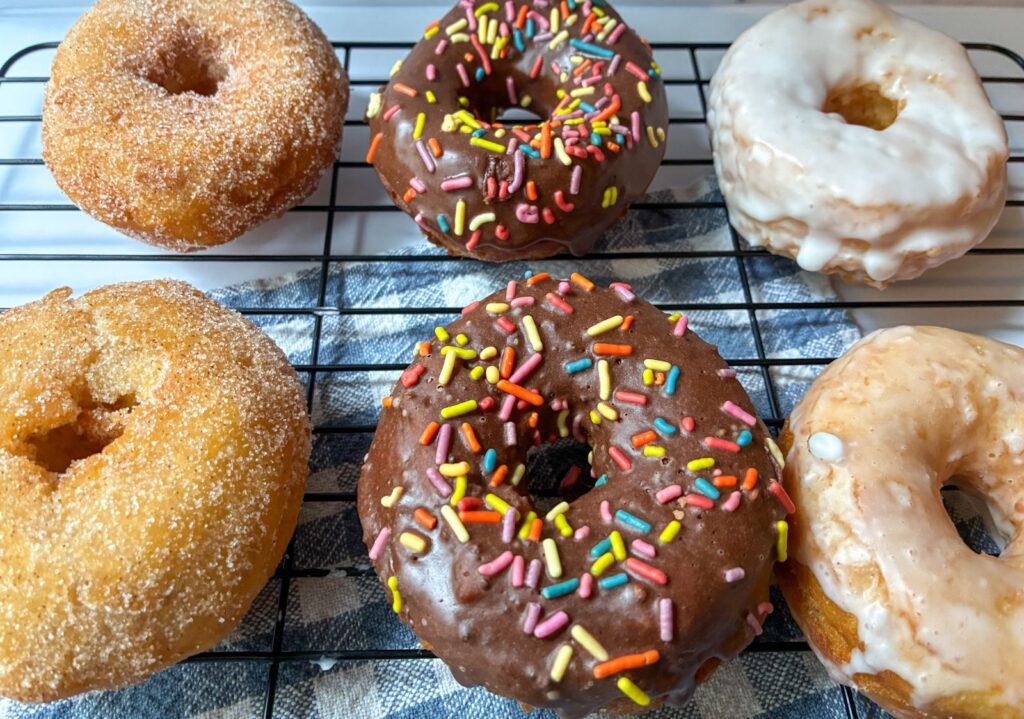 6 donuts on a cooling rack, 2 donuts of each flavor