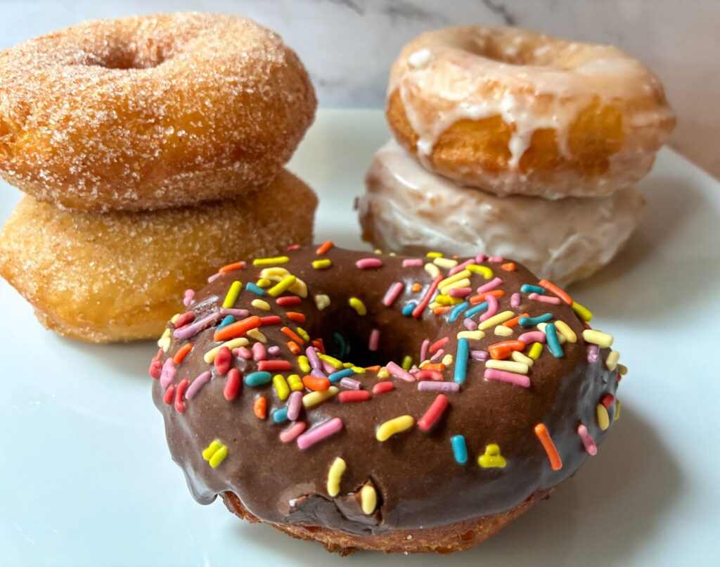 5 canned biscuit donuts of different flavors