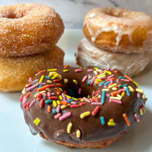 5 canned biscuit donuts of different flavors