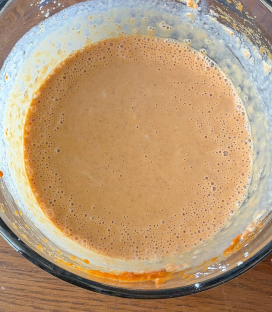 Eggless pumpkin pie filling in a large mixing bowl