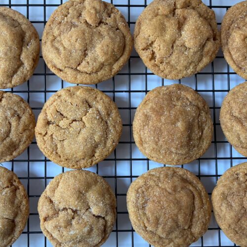 12 eggless molasses cookies on a cooling rack